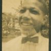 A blurry old photograph of a young man wearing a bowtie