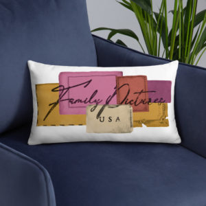 Family Pictures USA color logo on a rectangular white pillow displayed on a blue chair.