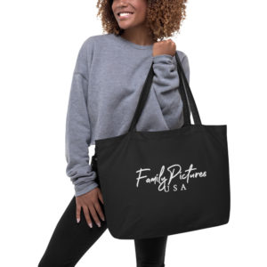 Model holds black tote with Family Pictures USA Logo in white