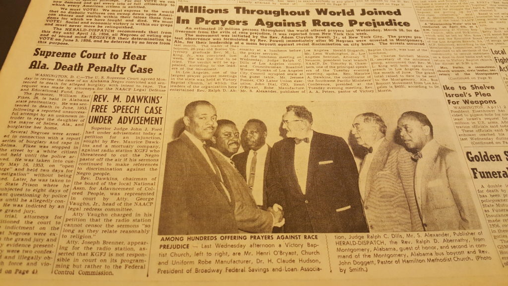 Newspaper article following Civil Rights story with a picture of Martin Luther King, Ralph Abernathy, and Rev Doggett